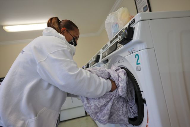 Lidia Vilorio, a home health aide, does her patient's laundry on May 05, 2021 in Haverstraw, New York.
